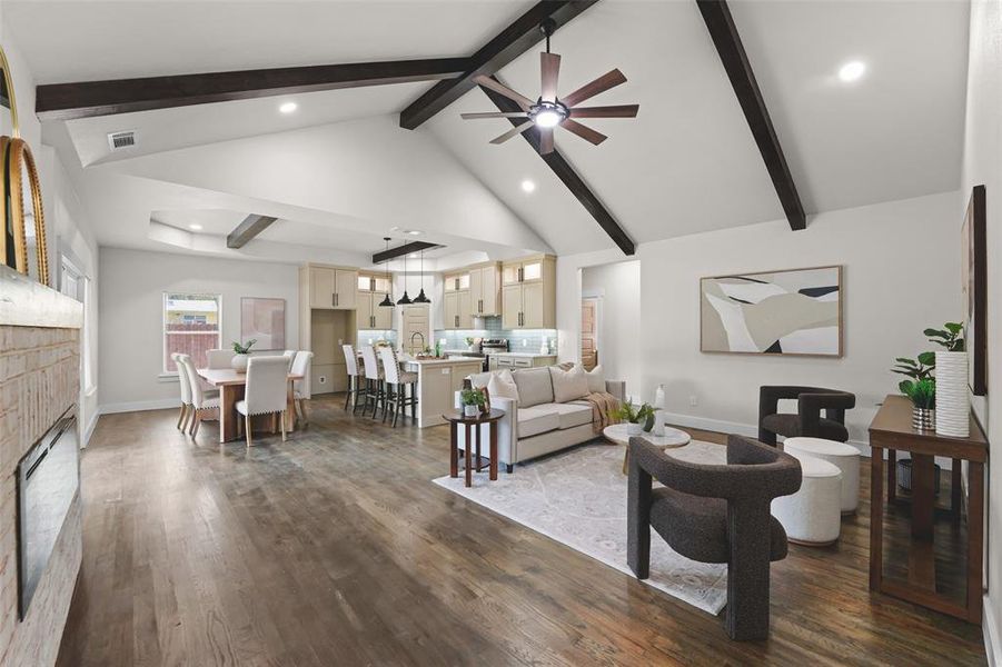 Spacious interior featuring wood-finish flooring, vaulted ceilings with exposed beams, recessed lighting, and a modern ceiling fan Spacious interior featuring wood-finish flooring, vaulted ceilings with exposed beams, recessed lighting, and a modern ceiling fan