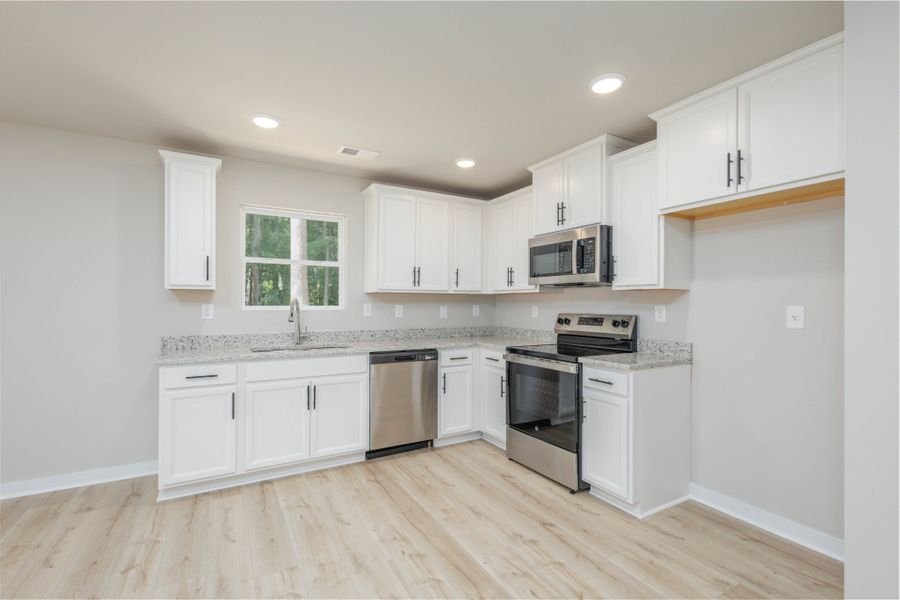 Kitchen with Granite Countertop, Kitchen window overlooks the wooded backyard