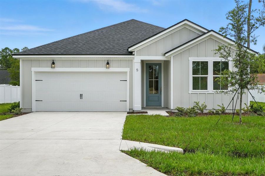 Front exterior of a new home in Palm Coast Homes, Palm Coast, FL, highlighting curb appeal (Image 1). Front exterior of a new home in Palm Coast Homes, Palm Coast, FL, highlighting curb appeal (Image 1).