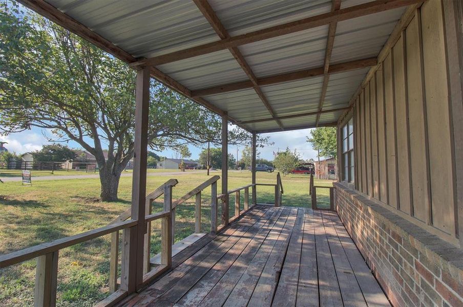 Deck featuring a lawn Deck featuring a lawn