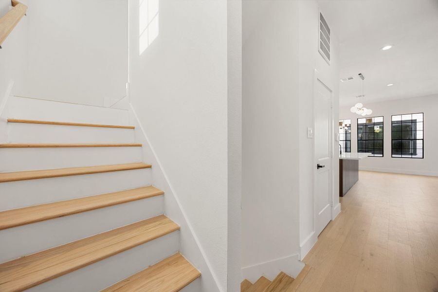 A stylish staircase leads to the third level, continuing the home's modern design while creating a seamless transition between living spaces.