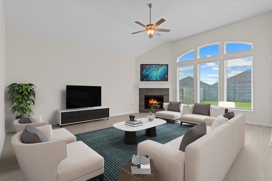 Spacious family room with vaulted ceilings, expansive windows, and a cozy gaslog fireplace, creating a warm and inviting gathering space. *Virtually Staged*