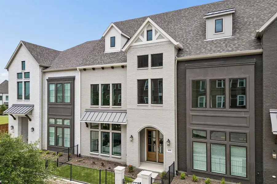 Front exterior of a new home in Newman Village Townhomes, Frisco, TX, highlighting curb appeal (Image 1). Front exterior of a new home in Newman Village Townhomes, Frisco, TX, highlighting curb appeal (Image 1).