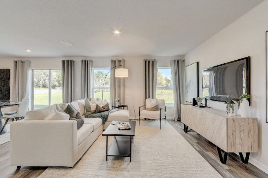 A living room with a large mirror. A living room with a large mirror.