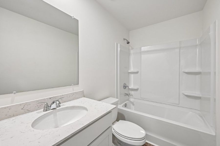 A bathroom with a sink and a toilet. A bathroom with a sink and a toilet.