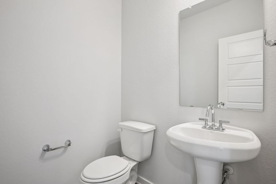 A bathroom with a toilet and sink.