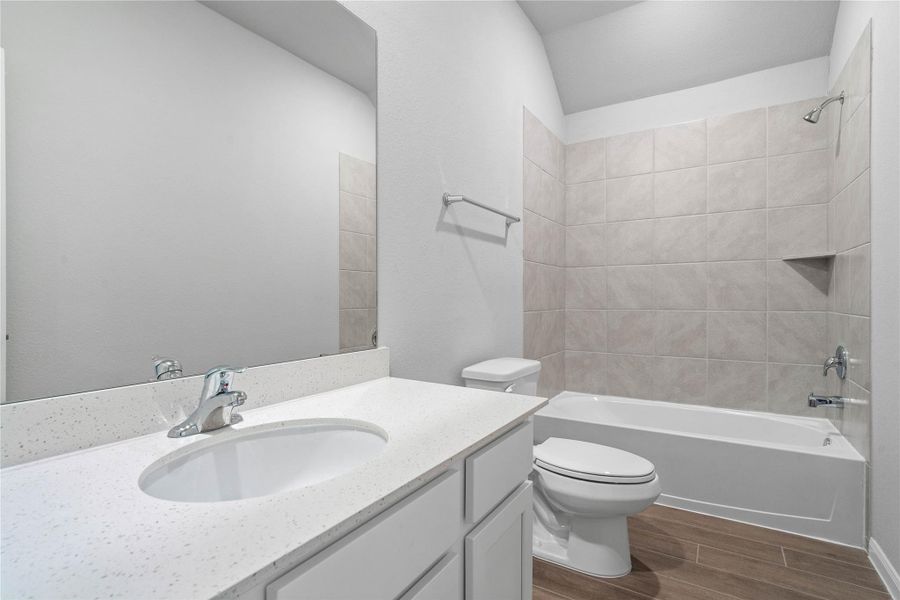 A streamlined secondary bathroom providing a functional tub/shower combination and modern fixtures, seamlessly blending practicality and style.