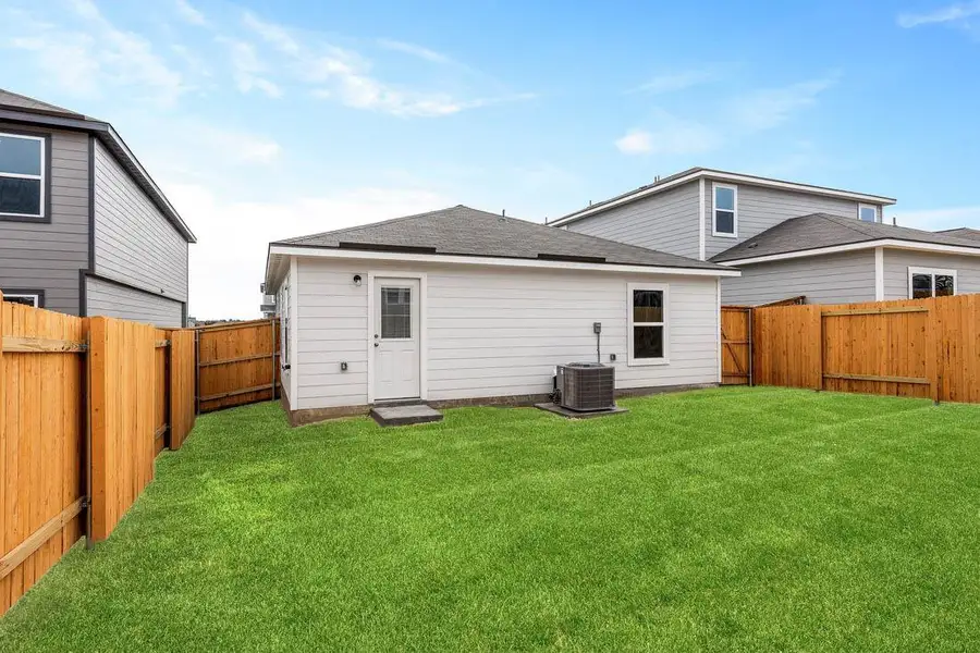 A fully enclosed grassy yard offers privacy and a clean slate for outdoor design.