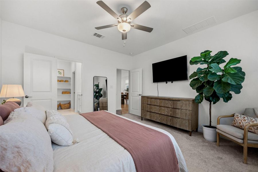 Bedroom featuring light-colored carpeting, a ceiling fan with integrated lighting, and white walls