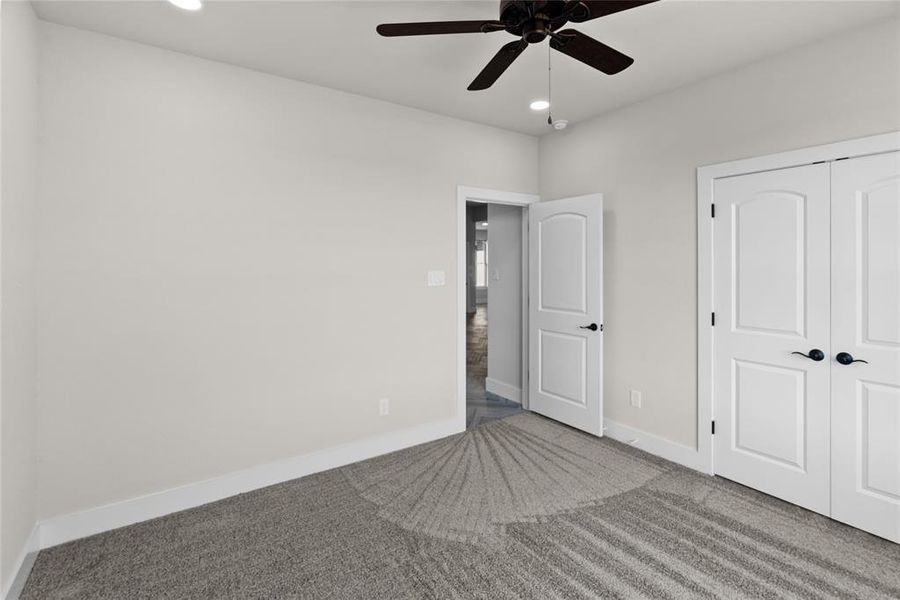 Unfurnished bedroom with carpet floors, a closet, and ceiling fan