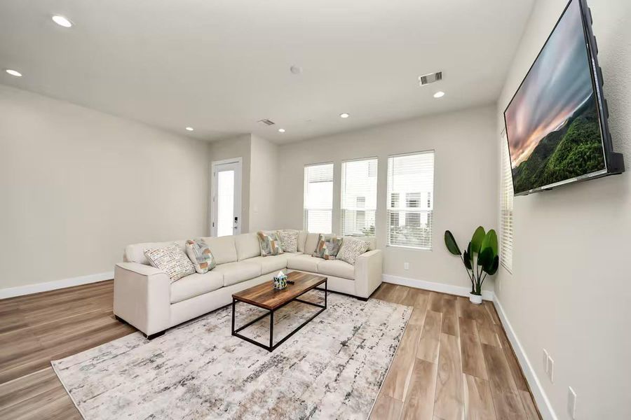 Large windows bring natural light into the heart of the home, while recessed lighting keeps the space bright well into the evening.