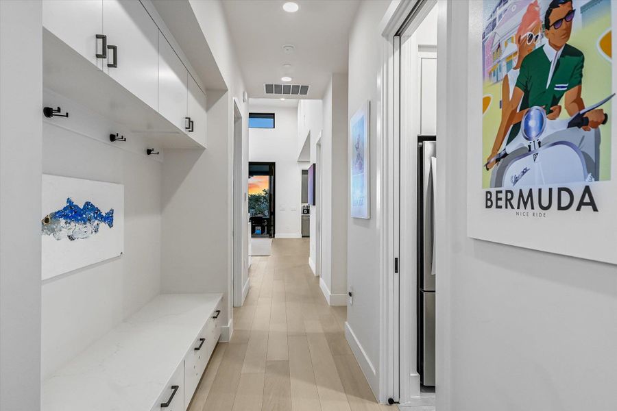 Mudroom featuring baseboards and light wood finished floors Mudroom featuring baseboards and light wood finished floors
