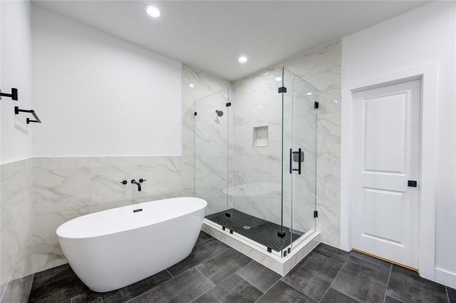 Frameless shower and soak in tub. Also includes a closed in water closet.