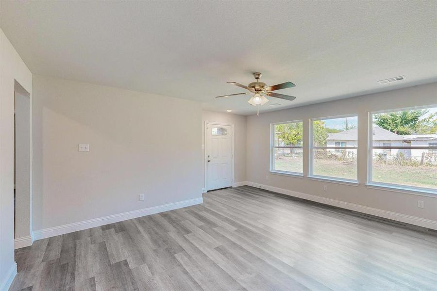 Unfurnished room featuring ceiling fan and light hardwood / wood-style floors