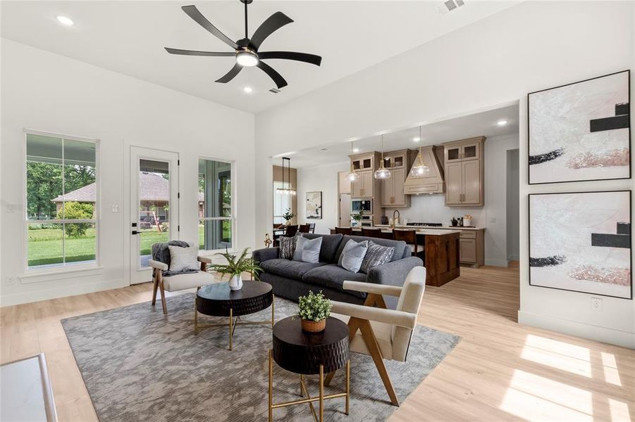 Living room with light wood-style floors, recessed lighting, and ceiling fan Living room with light wood-style floors, recessed lighting, and ceiling fan