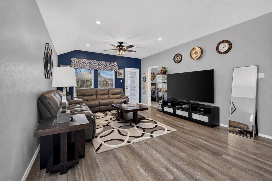 Spacious living room features vinyl plank flooring, recessed lighting, a ceiling fan and plenty of natural light. Spacious living room features vinyl plank flooring, recessed lighting, a ceiling fan and plenty of natural light.