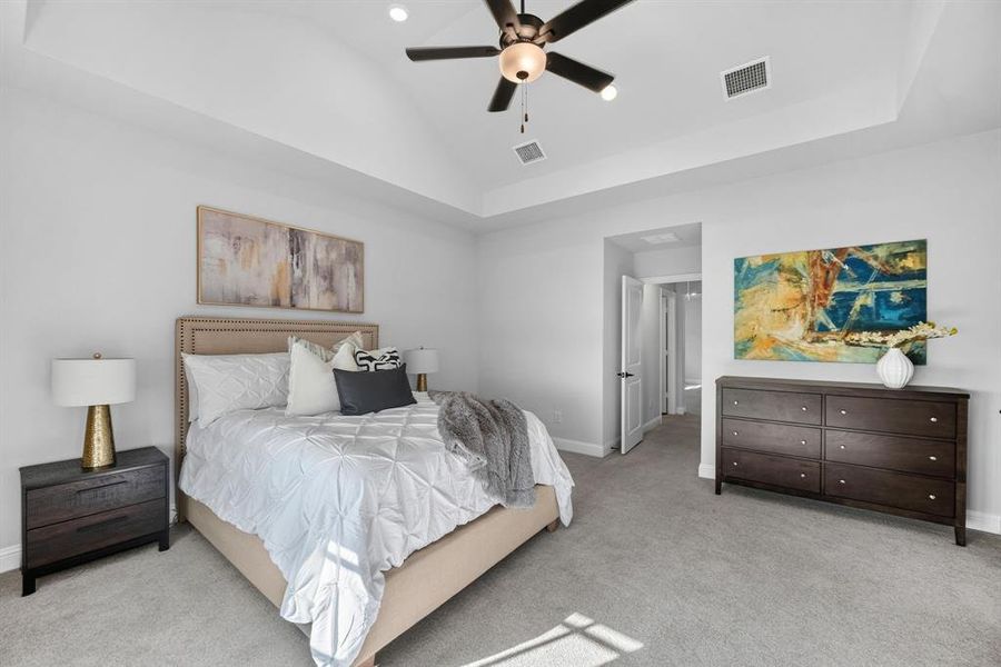 Spacious bedroom featuring vaulted ceilings, recessed lighting, and light grey carpeting