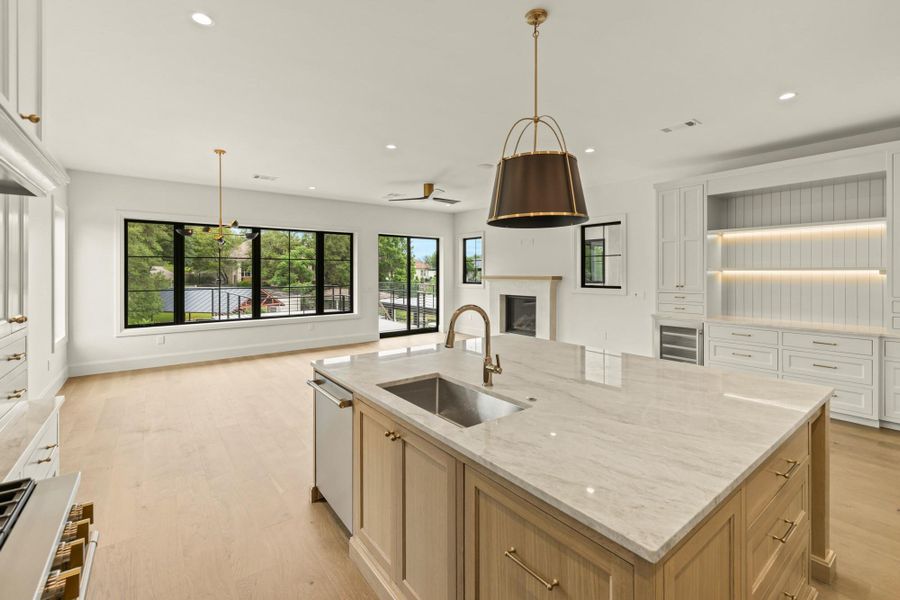 Kitchen featuring a sink, open floor plan, recessed lighting, a center island with sink, and stainless steel dishwasher