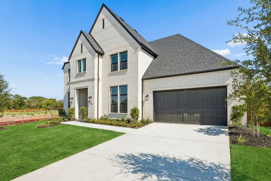 Front exterior of a new home in The Parks at Wilson Creek, Celina, TX, highlighting curb appeal (Image 2). Front exterior of a new home in The Parks at Wilson Creek, Celina, TX, highlighting curb appeal (Image 2).