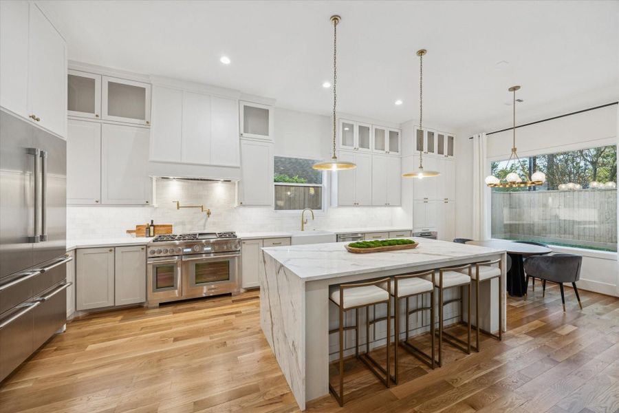 Centered around an oversized waterfall island, the kitchen balances high design with everyday usability. Professional grade Thermador appliances, generous prep space, and abundant storage allow the space to support everything from casual meals to large scale entertaining with ease. Centered around an oversized waterfall island, the kitchen balances high design with everyday usability. Professional grade Thermador appliances, generous prep space, and abundant storage allow the space to support everything from casual meals to large scale entertaining with ease.