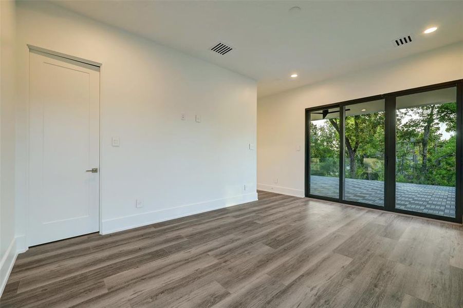 Sliding glass doors seperate the exterior oasis to this spacious bedroom that could be another primary suite.