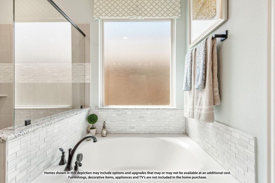 Soaking tub with white subway tile surround, frosted window, and glass shower enclosure nearby Soaking tub with white subway tile surround, frosted window, and glass shower enclosure nearby