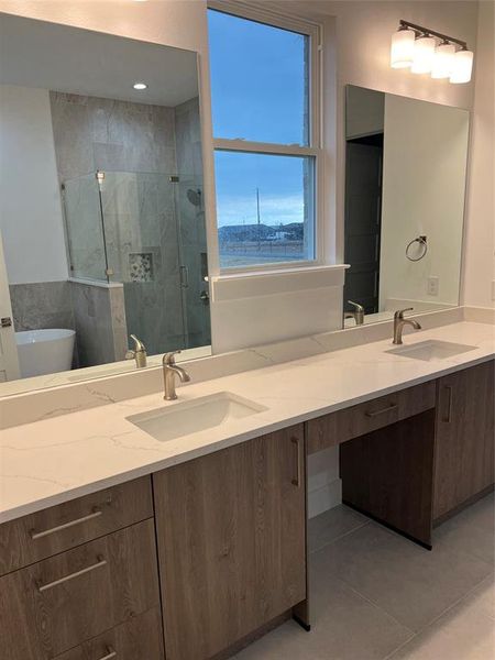 Bathroom with tile patterned floors, vanity, and plus walk in shower