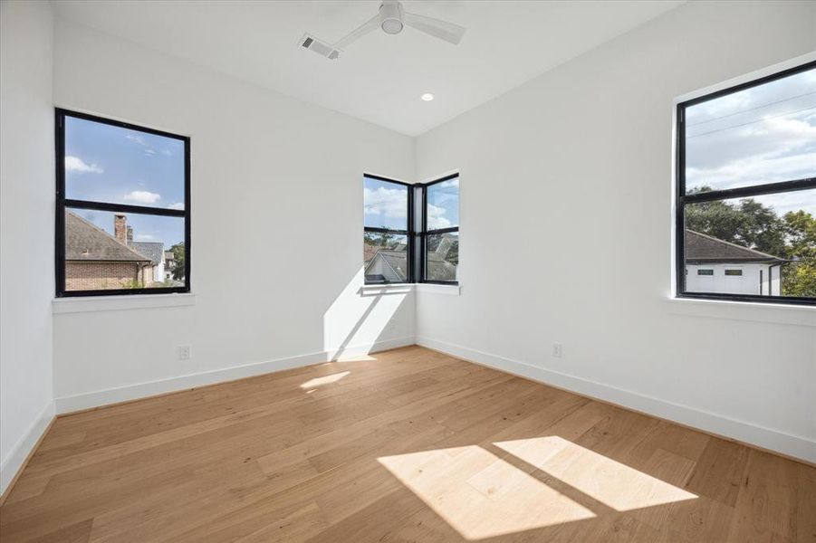 Very well lit rear bedroom with large corner windows.