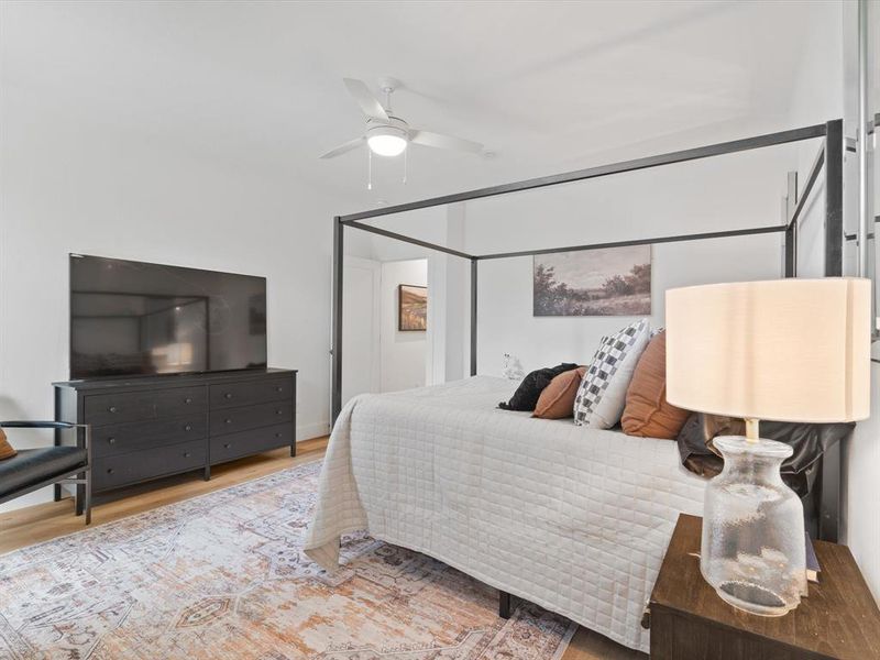 Bedroom featuring a ceiling fan and wood finished floors Bedroom featuring a ceiling fan and wood finished floors