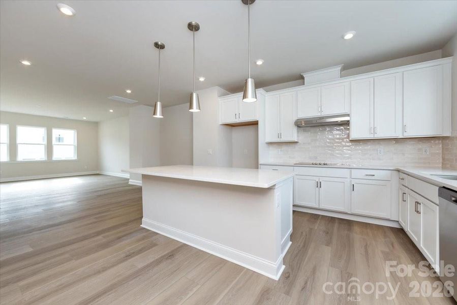 Gourmet Kitchen Anchors the Second Floor with Clean White Cabinets and Quartz Countertops Gourmet Kitchen Anchors the Second Floor with Clean White Cabinets and Quartz Countertops