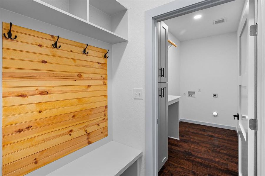 Mudroom with dark wood-style flooring and baseboards