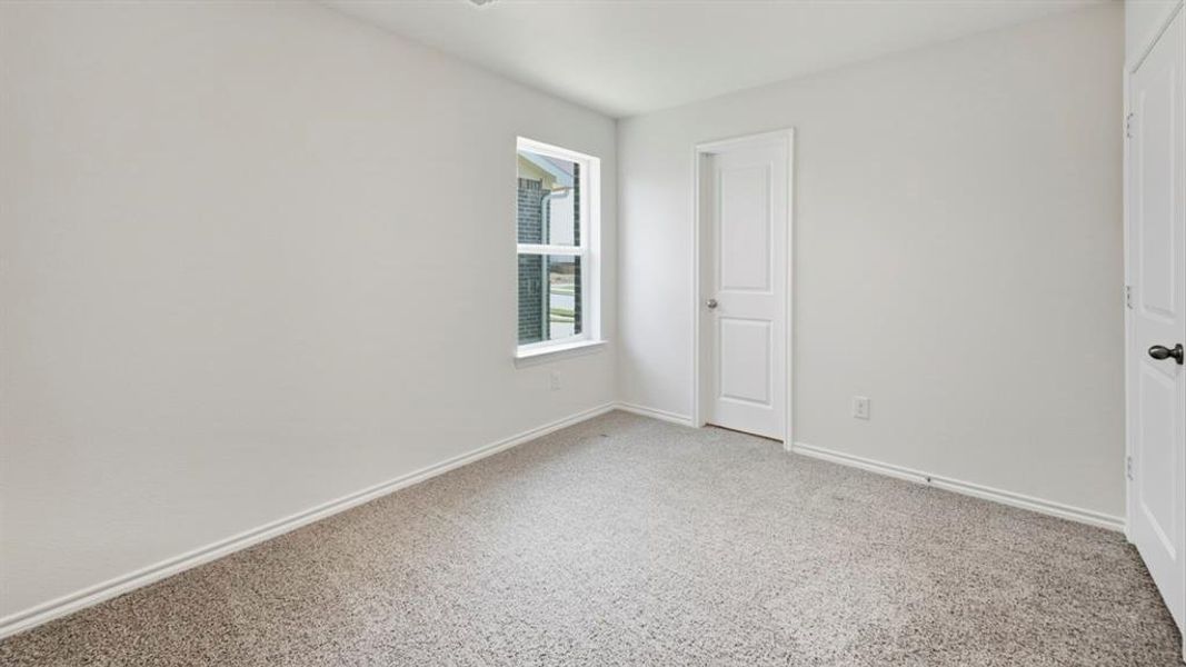 Unfurnished bedroom featuring light colored carpet and a closet