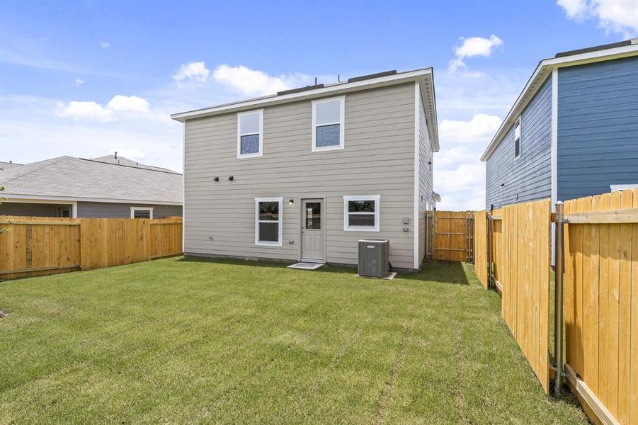 Rear view of property featuring a lawn