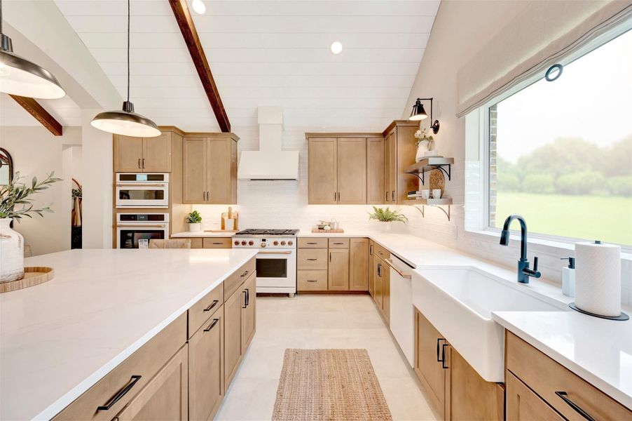 Stylish kitchen with light stain cabinets and quartz counters (*Photo not of actual home and used for illustration purposes only.)