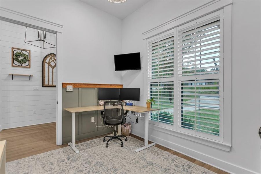 Office area featuring wood finished floors and board and batten wall accents. Could also be a 4th bedroom. Office area featuring wood finished floors and board and batten wall accents. Could also be a 4th bedroom.