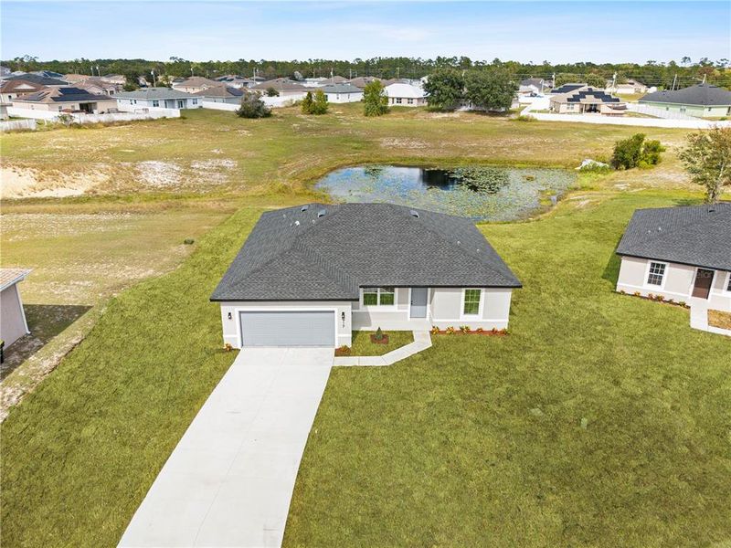 Front exterior of a new home in , Poinciana, FL, highlighting curb appeal (Image 19). Front exterior of a new home in , Poinciana, FL, highlighting curb appeal (Image 19).