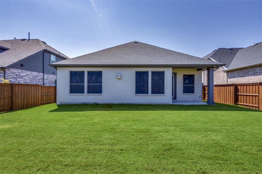 Rear Patio and large yard with luscious green grass Rear Patio and large yard with luscious green grass