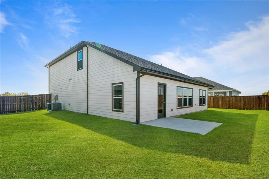 Rear view of property featuring a patio, central AC unit, and a lawn Rear view of property featuring a patio, central AC unit, and a lawn