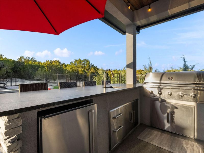 Patio / terrace featuring an outdoor kitchen and a sink