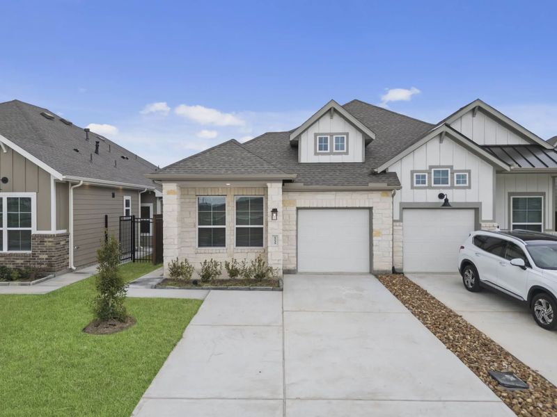Representative exterior photo of a completed home built from the Carriagehouse by Chesmar Homes in Meridiana Townhomes, Iowa Colony, TX (Image 38).
