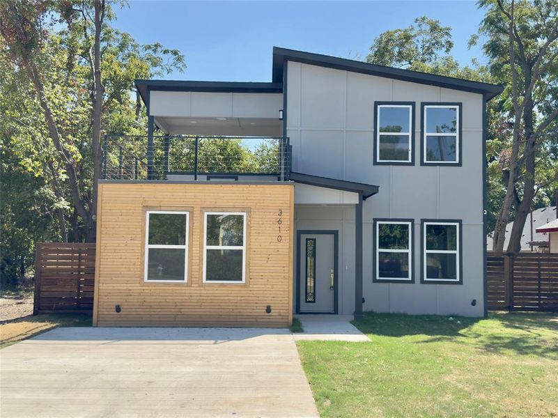 Contemporary home featuring a front lawn