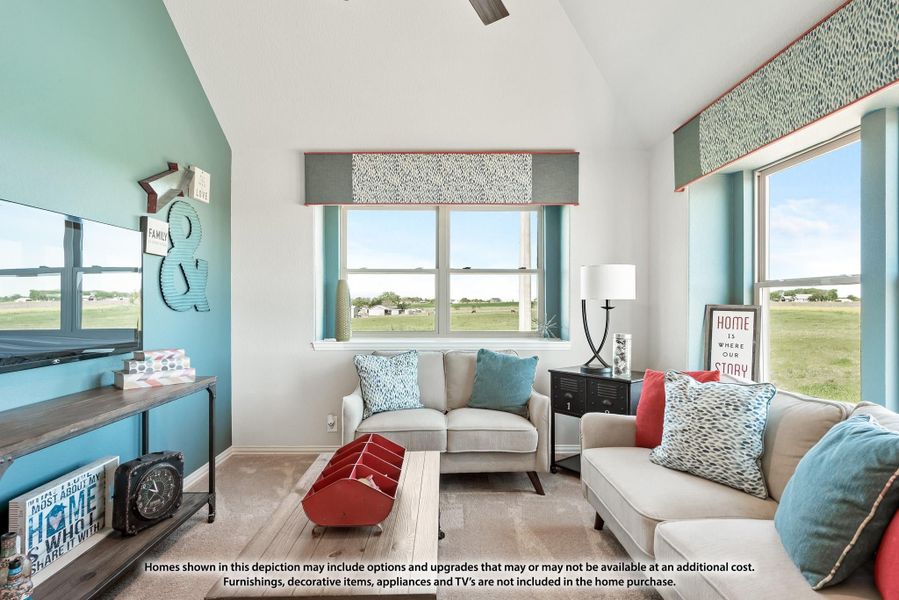 Living room with vaulted ceiling, teal accent wall, two sofas, and large windows with open field views. Living room with vaulted ceiling, teal accent wall, two sofas, and large windows with open field views.