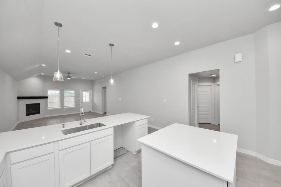 All of this overlooks your expansive family room, creating a perfect space for culinary delights and family gatherings. Sample photo of completed home with similar floor plan. Actual colors and selections may vary.