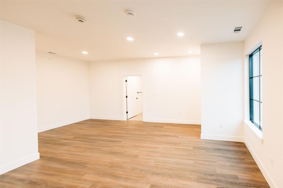 Empty room with recessed lighting and light wood finished floors