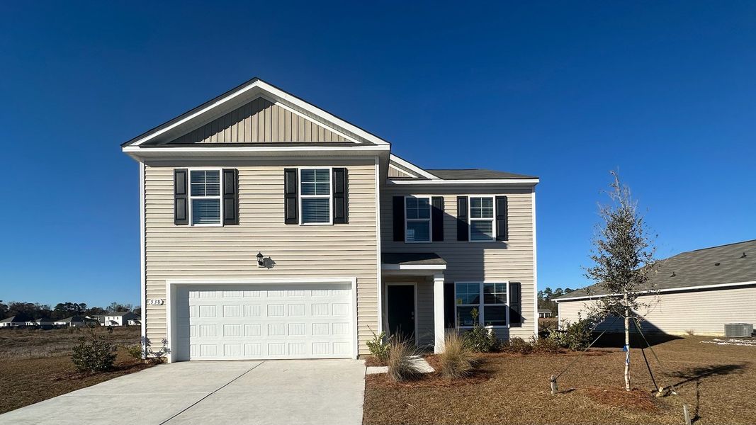 Front exterior of a new home in Heritage Crossing, Conway, SC, highlighting curb appeal (Image 1).