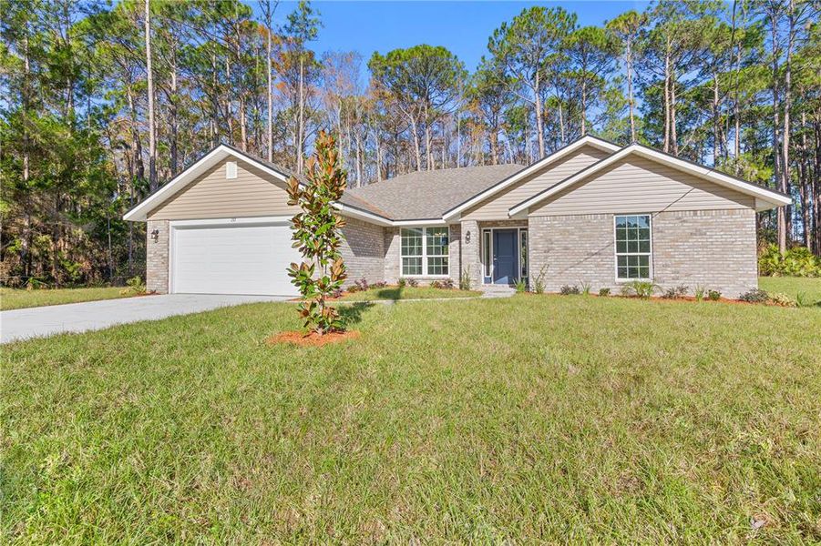 Front exterior of a new home in Palm Coast, Palm Coast, FL, highlighting curb appeal (Image 19). Front exterior of a new home in Palm Coast, Palm Coast, FL, highlighting curb appeal (Image 19).