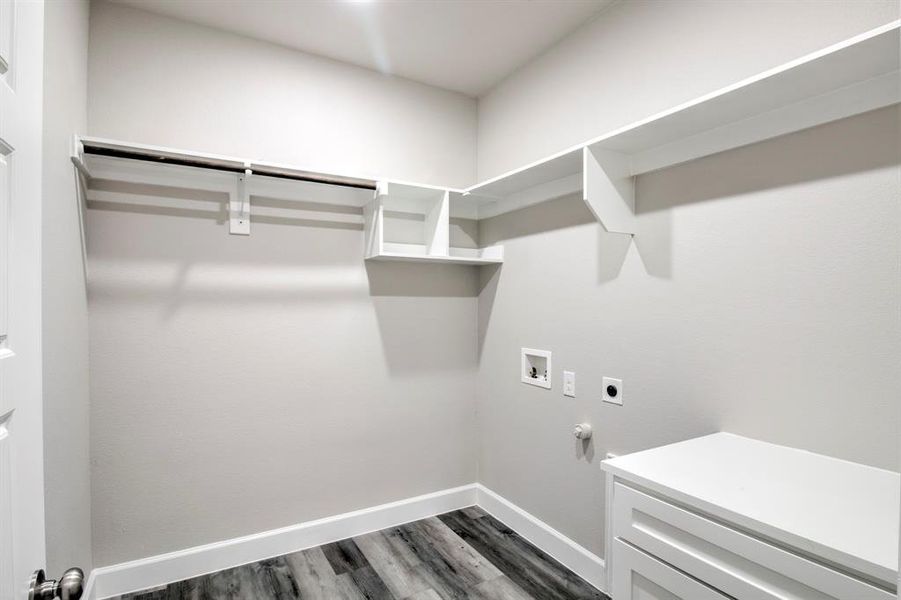 Laundry room with washer hookup, electric dryer hookup, hookup for a gas dryer, and dark wood-style flooring