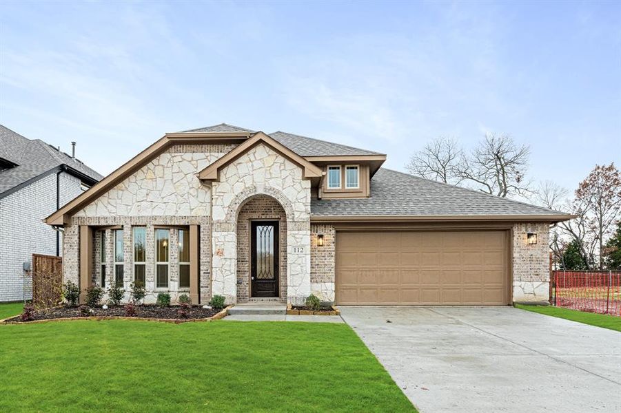 Front exterior of a new home in East Oak Creek 50-55, Commerce, TX, highlighting curb appeal (Image 1). Front exterior of a new home in East Oak Creek 50-55, Commerce, TX, highlighting curb appeal (Image 1).