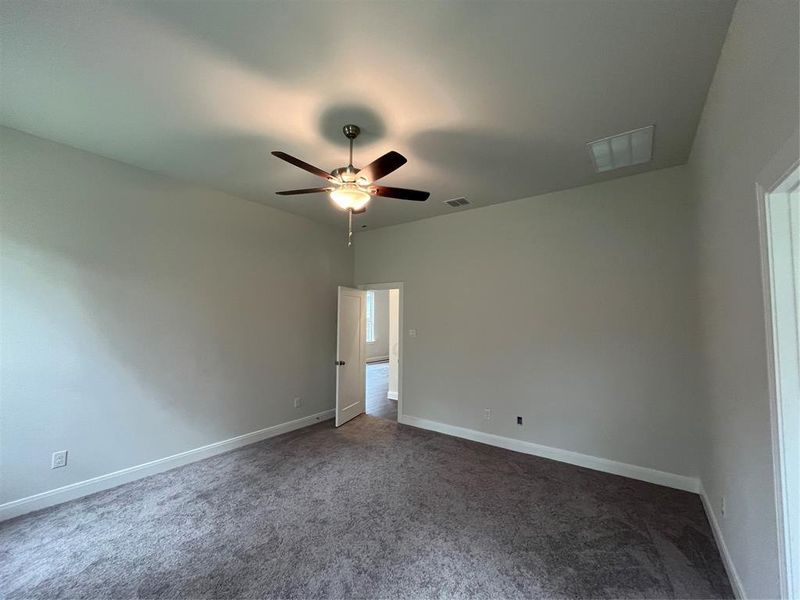 Ample primary bedroom space with 10’ high ceilings will be your personal sanctuary