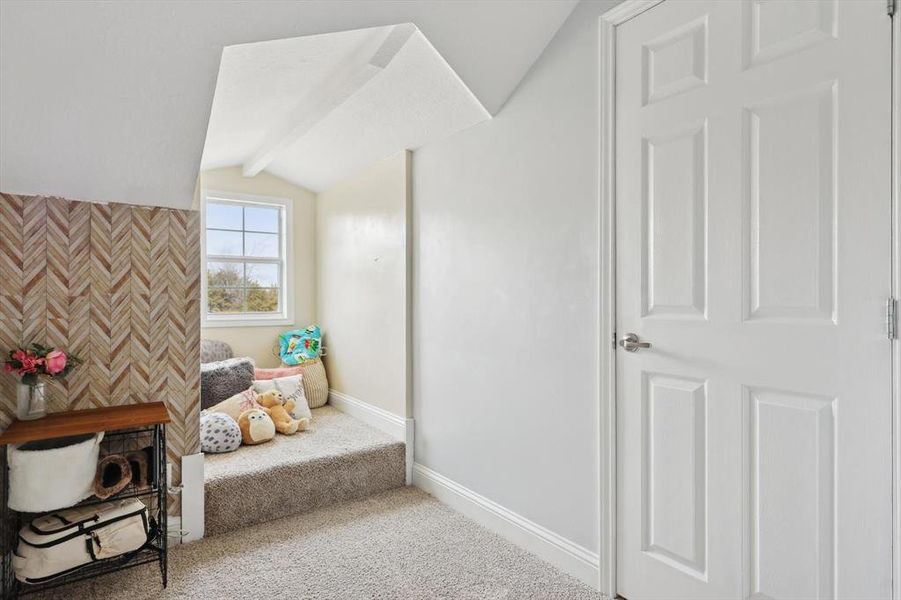 Sitting room with lofted ceiling and carpet floors